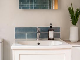 A sink with faucet and soap dispenser at a bathroom