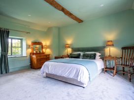 A bedroom with a bed and furniture at The Old Barn in Manchester