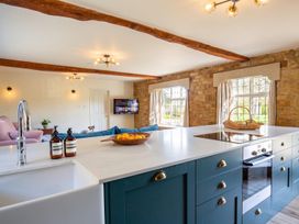 A kitchen with a sink and stove at The Old Barn in Manchester