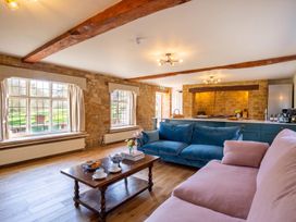 A living room with a blue sofa and coffee table at The Old Barn in Manchester