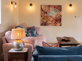 A living room with a sofa, lamp and decorative bowl at the property in the location