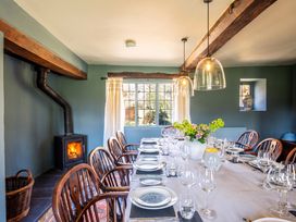 A dining room with a long table set for meal at the property