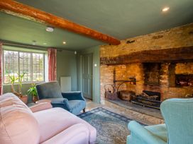 A living room with a fireplace and sofa at The Old Barn in Manchester