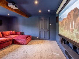 A home theater with red sofa and projector screen at 
