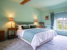 A bedroom with a bed and lamps at The Old Barn in Manchester