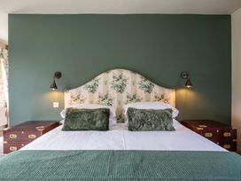 A bedroom with a bed and bedside tables at 