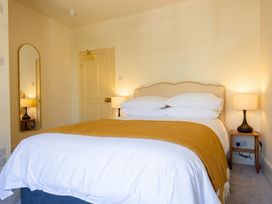 A bedroom with a bed and a mirror at The Old Barn in Manchester