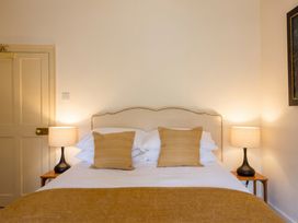 A bedroom with a bed and bedside lamps at the property