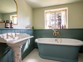 A bathroom with a bathtub and sink at The Old Barn in Manchester