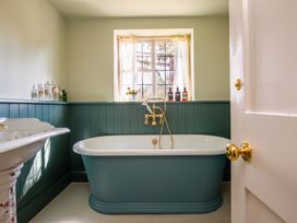 A bathroom with a bathtub and sink at The Old Barn in Manchester
