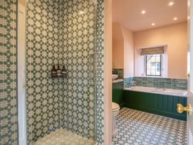 A bathroom with shower, bathtub, sink, and toilet at the property in the location