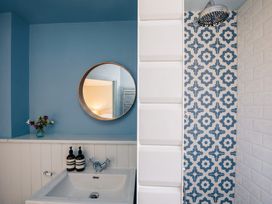 A bathroom with a sink and shower area at the property in the location