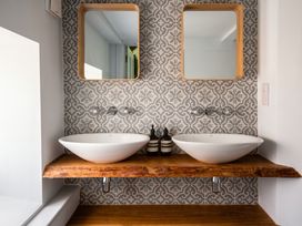 A bathroom with two sinks and mirrors at the property location