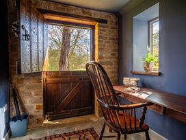 An office with a wooden chair and a desk beside an open door at the property in 