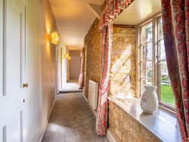 A hallway with a window and a radiator at the property