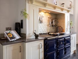 A kitchen with a stove and cookbook at the property in location
