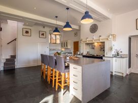 A kitchen with a central island and bar stools at a property