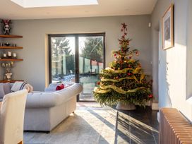 A living room with a Christmas tree and a sofa at the property in the location