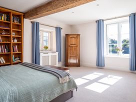 A bedroom with a bed, bookshelf, and wardrobe at The Old Barn in Manchester