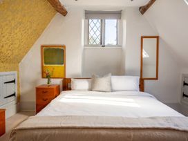 A bedroom with a bed and mirror at the property in unspecified location