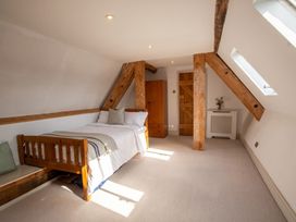 A bedroom with a bed and wooden furniture at The Old Barn in Manchester