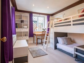 A bedroom with a bunk bed and desk at a property