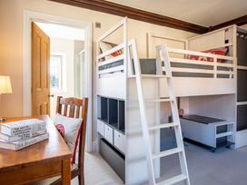 A bedroom with a loft bed and a study area at The Old Barn in Manchester