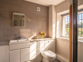 A bathroom with a sink, toilet, and window at 