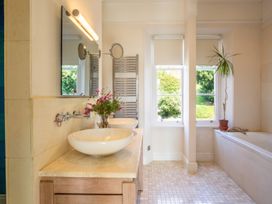 A bathroom with sinks and a bathtub at The Old Barn in Manchester