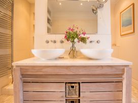 A bathroom featuring double sinks and a towel warmer