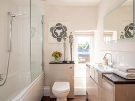 A bathroom with a shower, sink, and decorative elements at The Old Barn in Manchester
