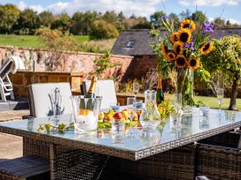An outdoor dining area with a table set for drinks at 