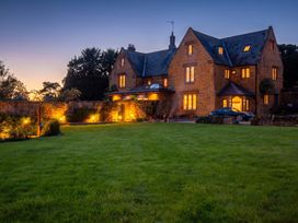 A house with lights on and a car parked in front at 