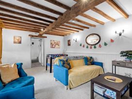 A snug with a foosball table and couches at The Old Barn in Manchester