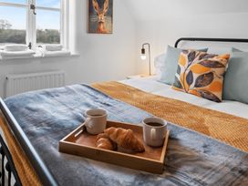 A bedroom with a bed and breakfast items at The Old Barn in Manchester