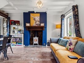 A living room with a fireplace and sofa at The Old Barn in Manchester