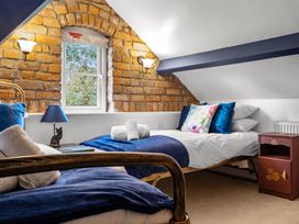 A bedroom with two beds and a window at The Old Barn in Manchester