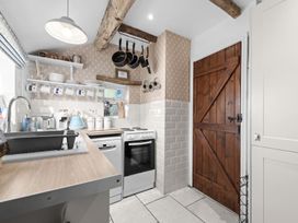 A kitchen with a sink, oven, and cabinets at the property in location