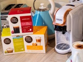 A coffee machine with coffee pods on a countertop in a kitchen