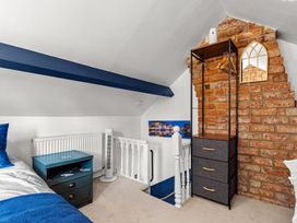A bedroom with a bed, nightstand and storage at 