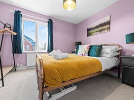 A bedroom with a bed and a window at The Old Barn in Manchester