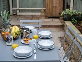 An outdoor dining area with a table set for breakfast at an unspecified location