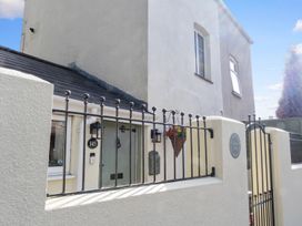 A house exterior with a gate and number 145 at The House in Unknown location
