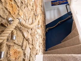 A staircase with a stone wall and handrail at 