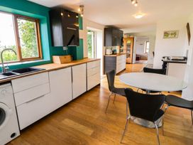A kitchen with a table and chairs at The Old Barn in Manchester
