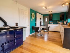 A kitchen with an AGA stove and a dining table at the property in the location
