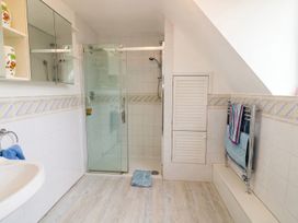 A bathroom with shower and sink at the property in the location