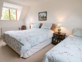 A bedroom with two beds and a nightstand at The Old Barn in Manchester