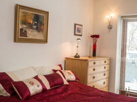 A bedroom with a bed and dresser at The Old Barn in Manchester