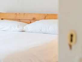 A bed with pillows in a bedroom at Furzen Farmhouse